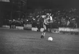 John Aston races to the ball