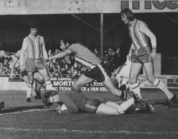 Jimmy Husband goes in hard on the Saints goalkeeper Jim Montgomery
