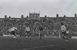 Ron Futcher heads the ball across