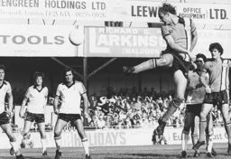 John Faulkner heads in the only goal of the game watched by a bemused George Best