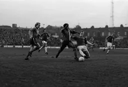 Ricky Hill beats the defender to the ball