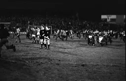 Not unusual pitch invasion at the end at the end of the match at the Den