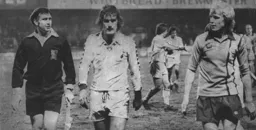 Paul Futcher leaves the field at the end with Glenn Hoddle