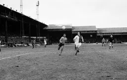 Brian Stein close on the heels of the defender