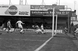 Alan West gets his cross in before nearly ending up in the Kenilworth Road end