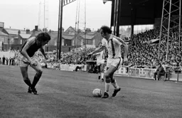Bob Hatton takes on a Swansea defender