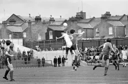 Brian Stein grapples with the Oldham centre half