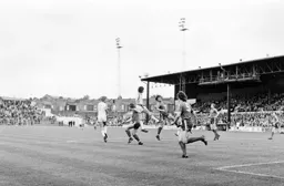 Mike Saxby gets his head to the ball first