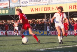 Mike Saxby keeps a close eye on Rangers striker Clive Allen