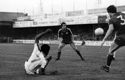 Ricky Hill on the floor but still gets the ball into the box