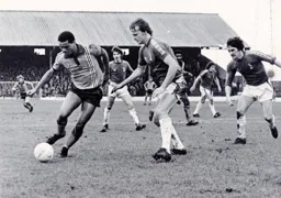 Brian Stein tries to get around the Latics defence