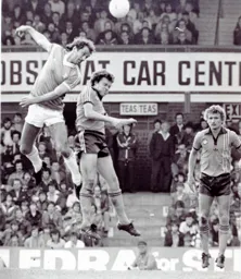 Mal Dongahy goes up with Blues Frank Worthington watched by Paul Price