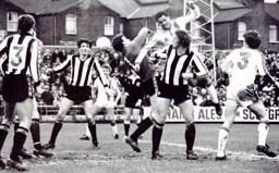 Brian Stein sees a header cleared watched by Mick Harford