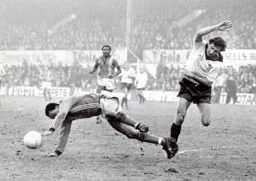 Brian Stein is tripped by Roy McFarland