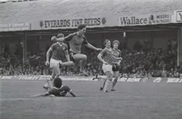 Mark Aizlewood jumps over Larry May