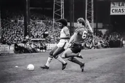 Ricky Hill challenged by Ipswich defender Terry Butcher