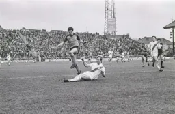 Steve White steps over the defender