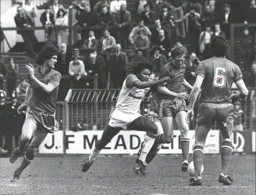 Ricky Hill takes on three Rovers defenders