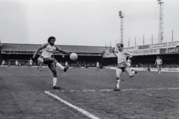 Ricky Hill lifts the ball over the defender