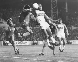 Looks a bit painful. Paul Walsh is on the receiving end of a robust challenge