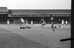 Paul Walsh hurdles the defender