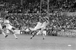 Raddy Antic and Paul Walsh challenge for the ball