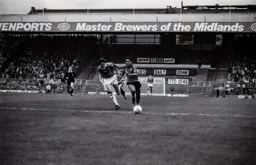 Brian Stein takes on a Blues defender