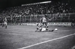 Brian Stein hurdles the defender