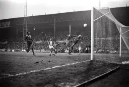 David Moss watches his chip from in front of the Main Stand float in the top corner