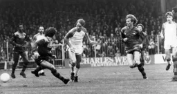 Paul Walsh takes on the Arsenal defence