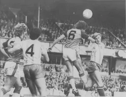Mal Donaghy heads the ball clear