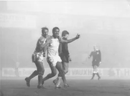The gloom is lifted as Paul Walsh and Brian Stein celebrate Stein`s goal to level things at 2-2