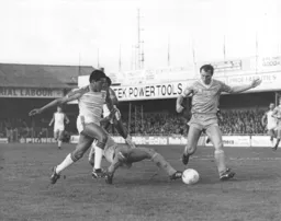 A City defender toe ends the ball away from Brian Stein