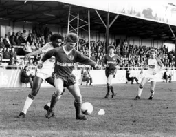 A Posh defender shields the ball from Ricky Hill