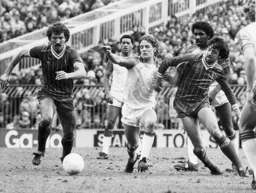 Paul Walsh in a midfield tussle