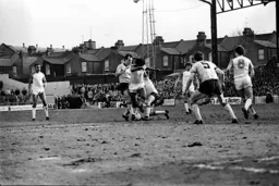 Ricky Hill gets between two defenders