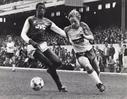Paul Walsh rounds an Arsenal defender