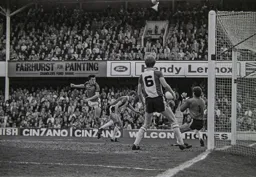 Trevor Aylott gets to the ball before ex Hatter Chris Nicholl