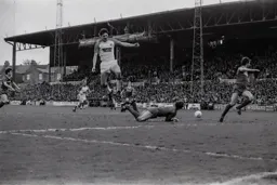 Trevor Aylott vaults the goalkeeper