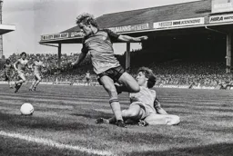 Paul Walsh is tackled by Ray Ranson