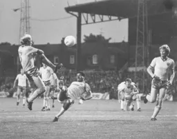 Brian Stein and Norwich`s Greg Downs both go for the ball.