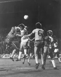 Norwich keeper Chris Woods knocks the ball away from Mal Donaghy