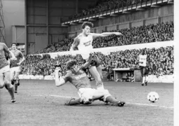 Terry Butcher knocks the ball away from Frank Bunn