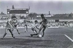Mitchell Thomas dribbles past a City defender