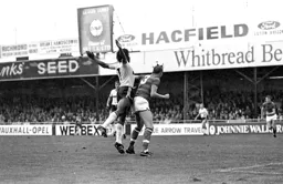 Ricky Hill lets the defender know he is behind him