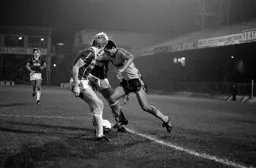 Brian Stein wriggles between two defenders