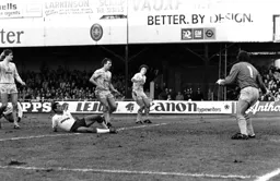 Brian Stein slides the ball into the Tottenham net