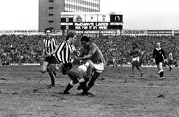 Brian Stein clashes with a Newcastle defender