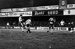 Mick Harford crashes a shot against the post