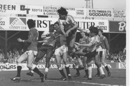 Mick Harford powers above a a pack of players to force the ball home after Foster's free kick rebounds off the bar